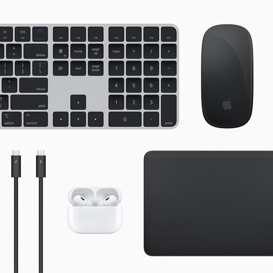 Vista de cima dos acessórios Mac: Magic Keyboard, Magic Mouse, Magic Trackpad, AirPods e cabos Thunderbolt